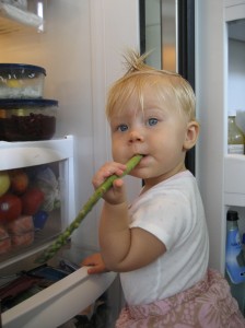 Kira eating veggies from fridge